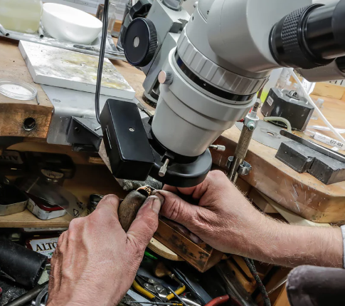 Jewelry inspection under a microscope during quality control